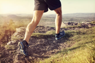 Outdoor cross-country running in summer sunshine concept for exercising, fitness and healthy lifestyle